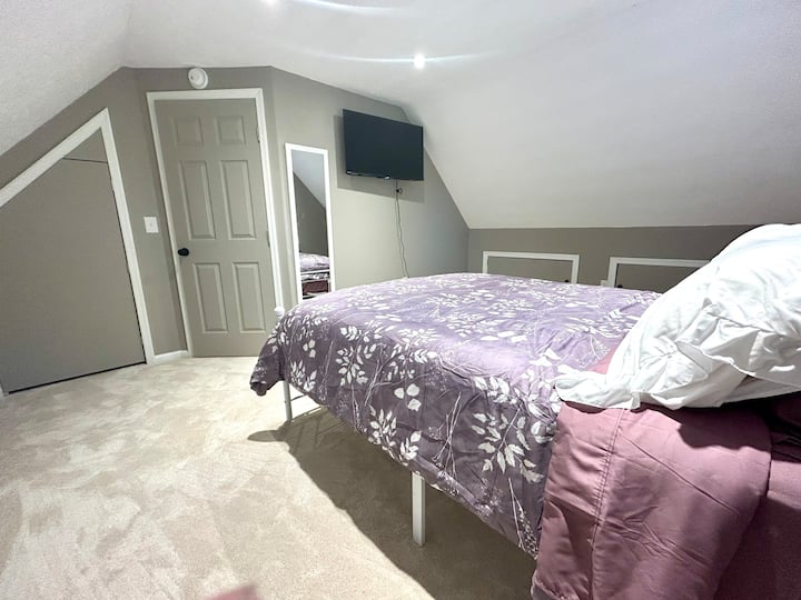 This bedroom has a queen bed and is located on the upper level of the home. It is the only room on that level.