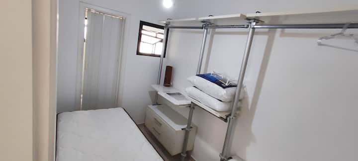 ห้องพร้อมเตียงเดี่ยวและตู้เสื้อผ้า มีห้องน้ำขนาดเล็กที่ยังไม่ได้ใช้งาน