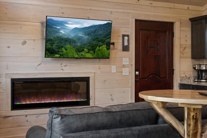 Living space with full kitchen, smart tv, dining, electric fireplace