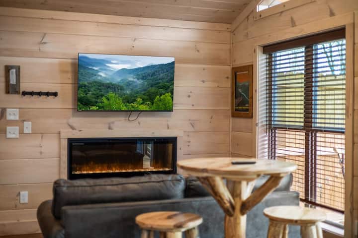 Living space with full kitchen, smart tv, dining, electric fireplace