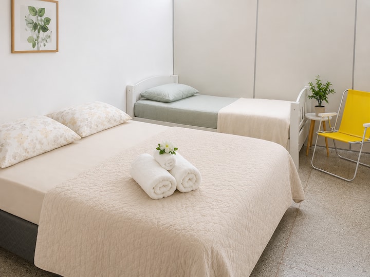 Single room with two beds, one double and one single. Accommodation for up to 3 guests. 

Beds come with duvets and towels, face and bath.