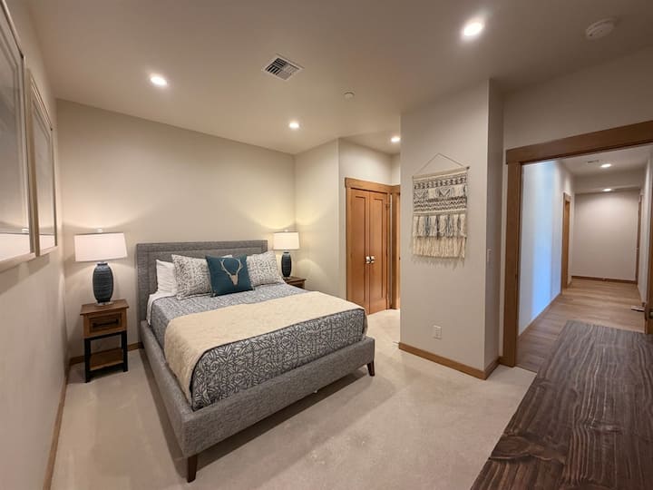 A serene retreat featuring upscale furnishings, soft textures, and modern mountain-inspired décor