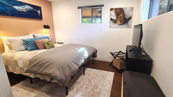 A complete look at your cozy bedroom retreat. Relax in a plush bed styled with unique textured quilts and colorful pillows, catch your favorite shows on the smart TV, and enjoy extras like a luggage rack and laundry hamper for a stress-free stay