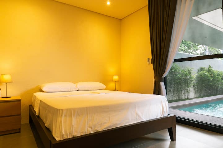 Queen-sized bed with direct access to the private pool.