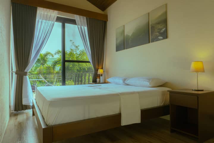 Spacious bedroom featuring a king-sized bed and a private ensuite bathroom