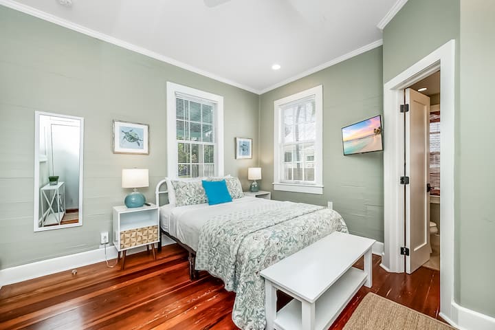 Primary bedroom with king bed and tropical accents