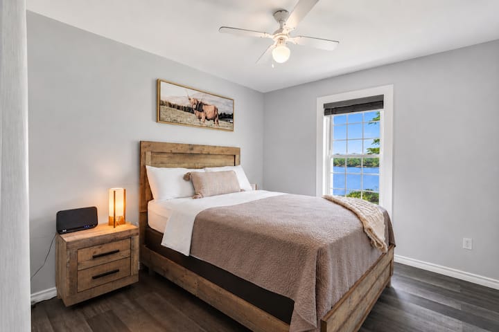 Cozy waterfront bedroom with rustic charm and serene lake views
