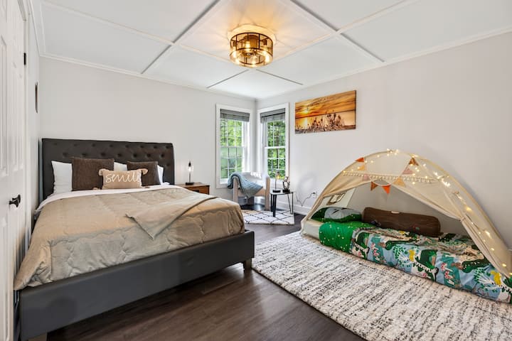 Family-friendly bedroom with cozy teepee bed and sunny reading nook