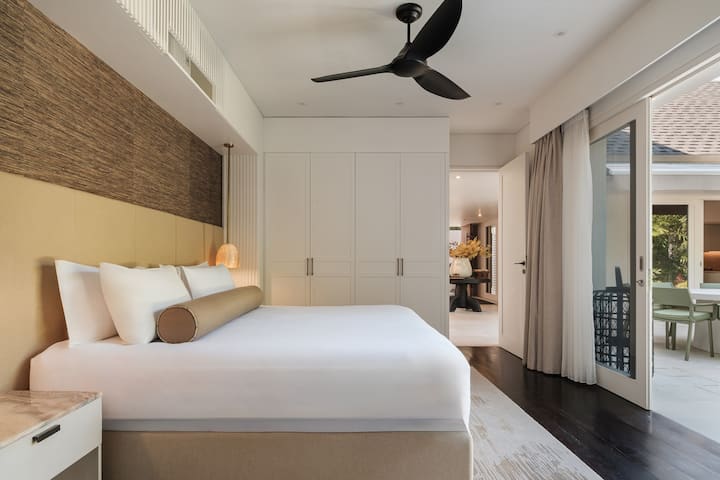 A serene king bedroom with generous built-in storage.