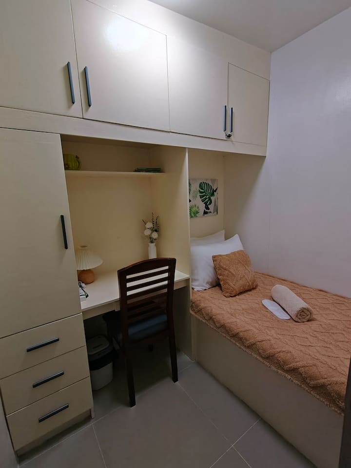 Second bedroom featuring clean built-in cabinetry and an integrated dedicated workspace.