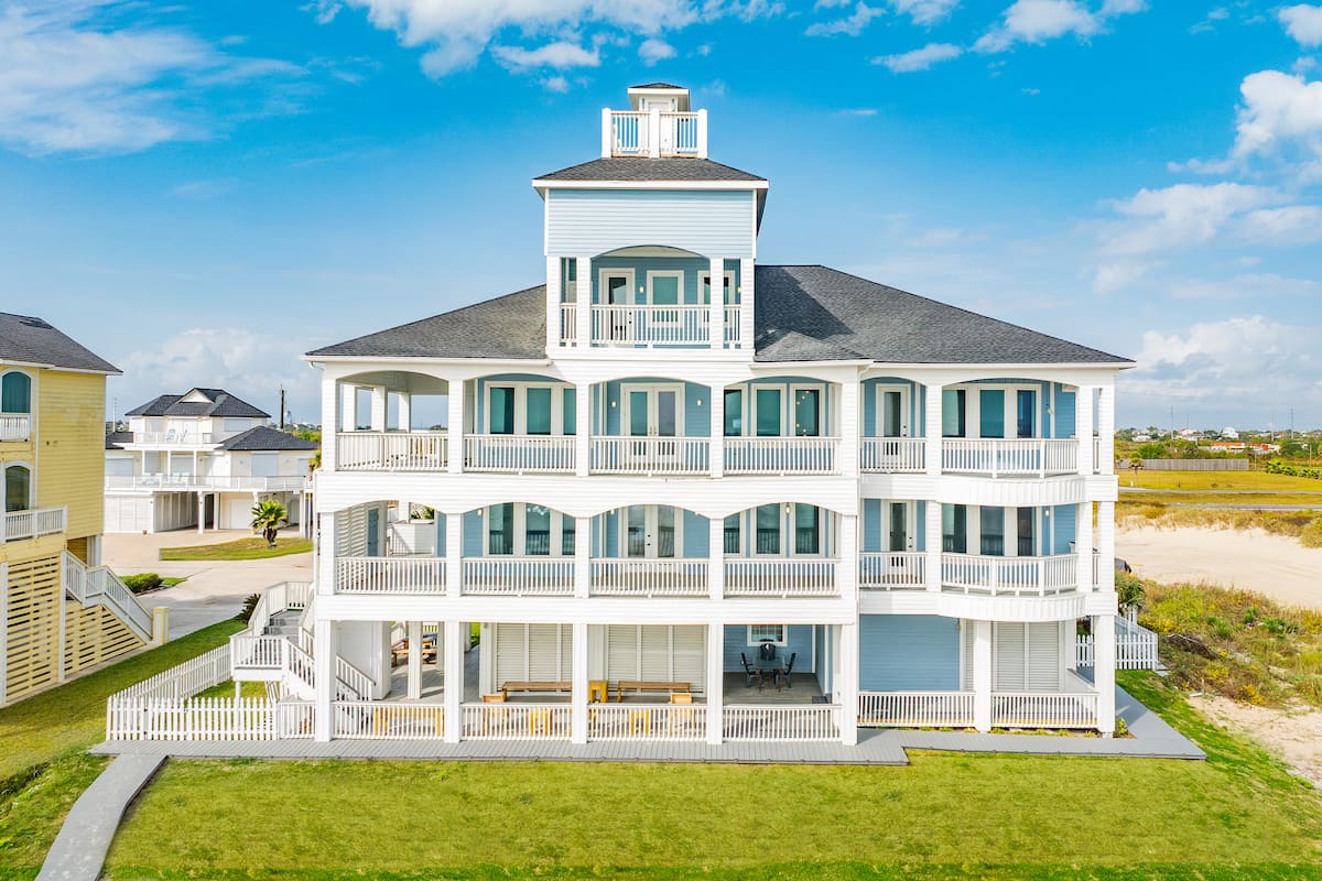 Beachfront estate exterior with multi-tier balconies facing the Gulf