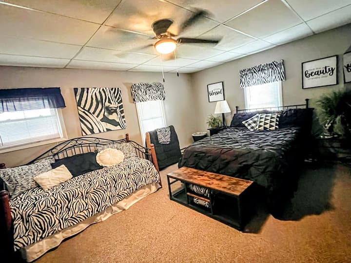 A comfy queen bed and a day bed that is a double make for a perfect family room.