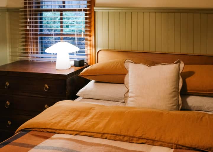 Cozy Queen retreat featuring warm tones and luxurious bedding.