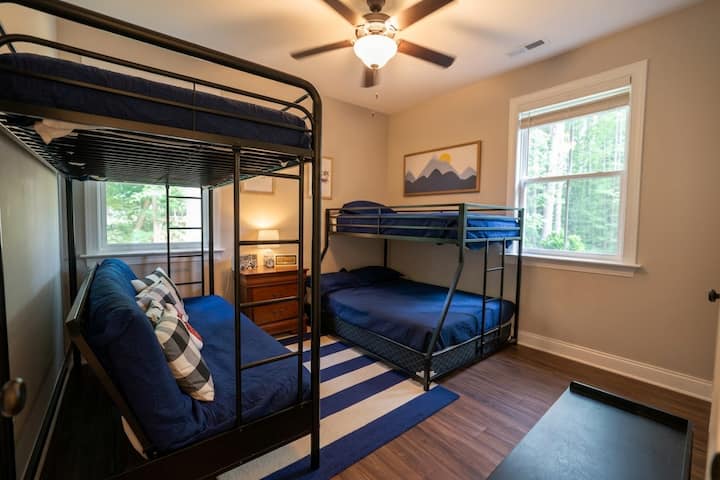 Bedroom 5, perfect for kids or extra guests, featuring two sturdy bunk beds and ample closet storage in a comfortable, bright space