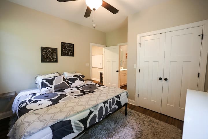 Cozy and well-appointed bedroom in the apartment area, featuring a plush king-sized bed, soft textures, and a private, peaceful atmosphere. Includes ample closet space and easy access to the suite's private bathroom facilities