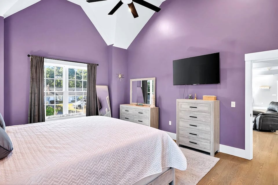 Primary suite with smart TV and ceiling fan