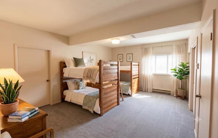 Two sets of twin bunk beds downstairs with a full bathroom and laundry room.
