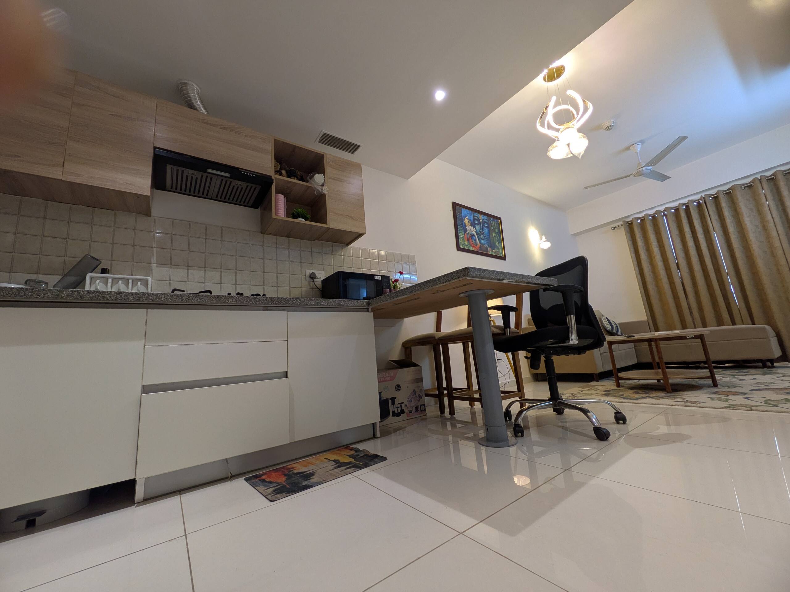 Open-plan kitchen with the work desk beyond
