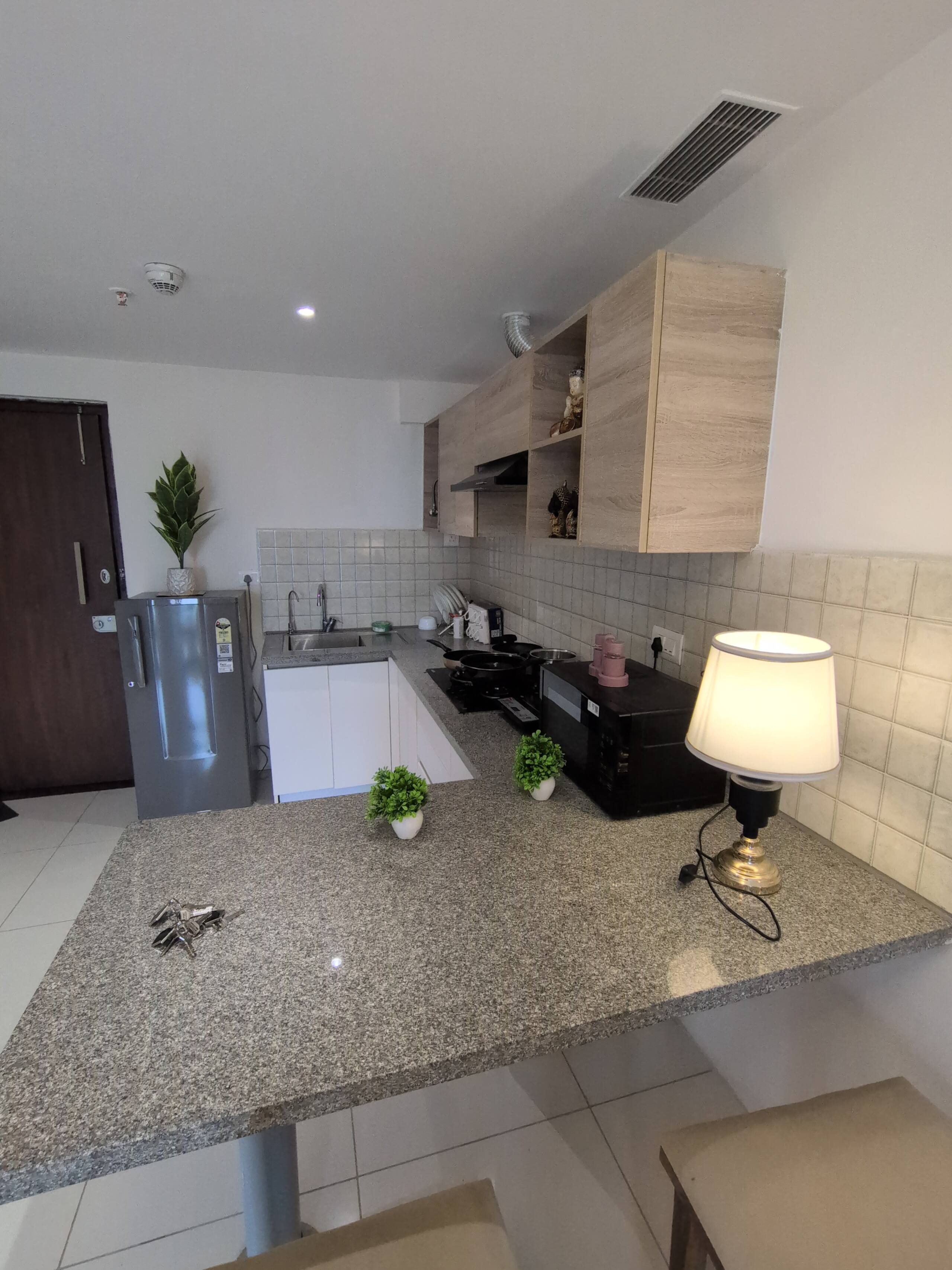 Kitchen with refrigerator and table lamp