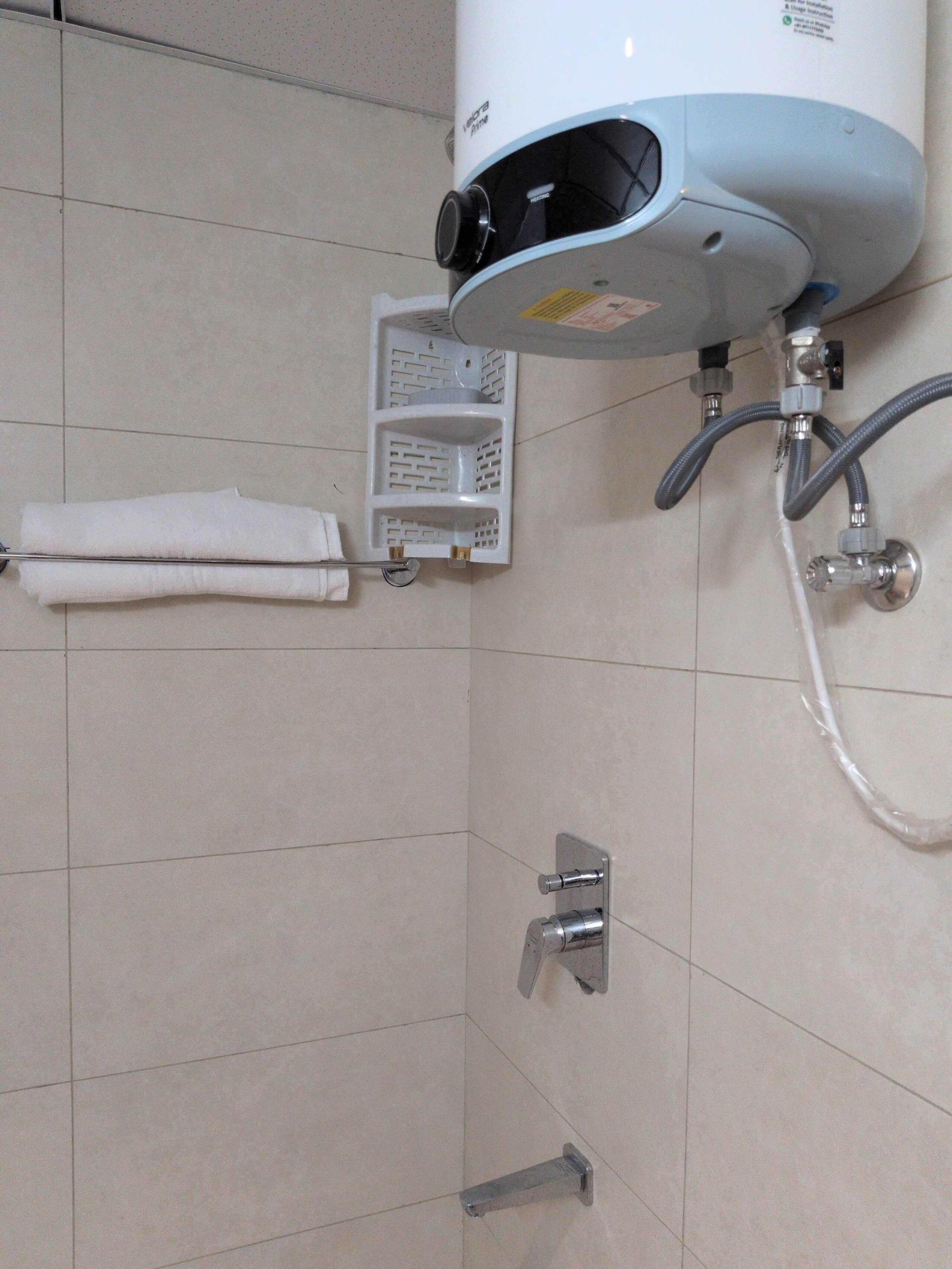 Shower area with geyser and towel rack