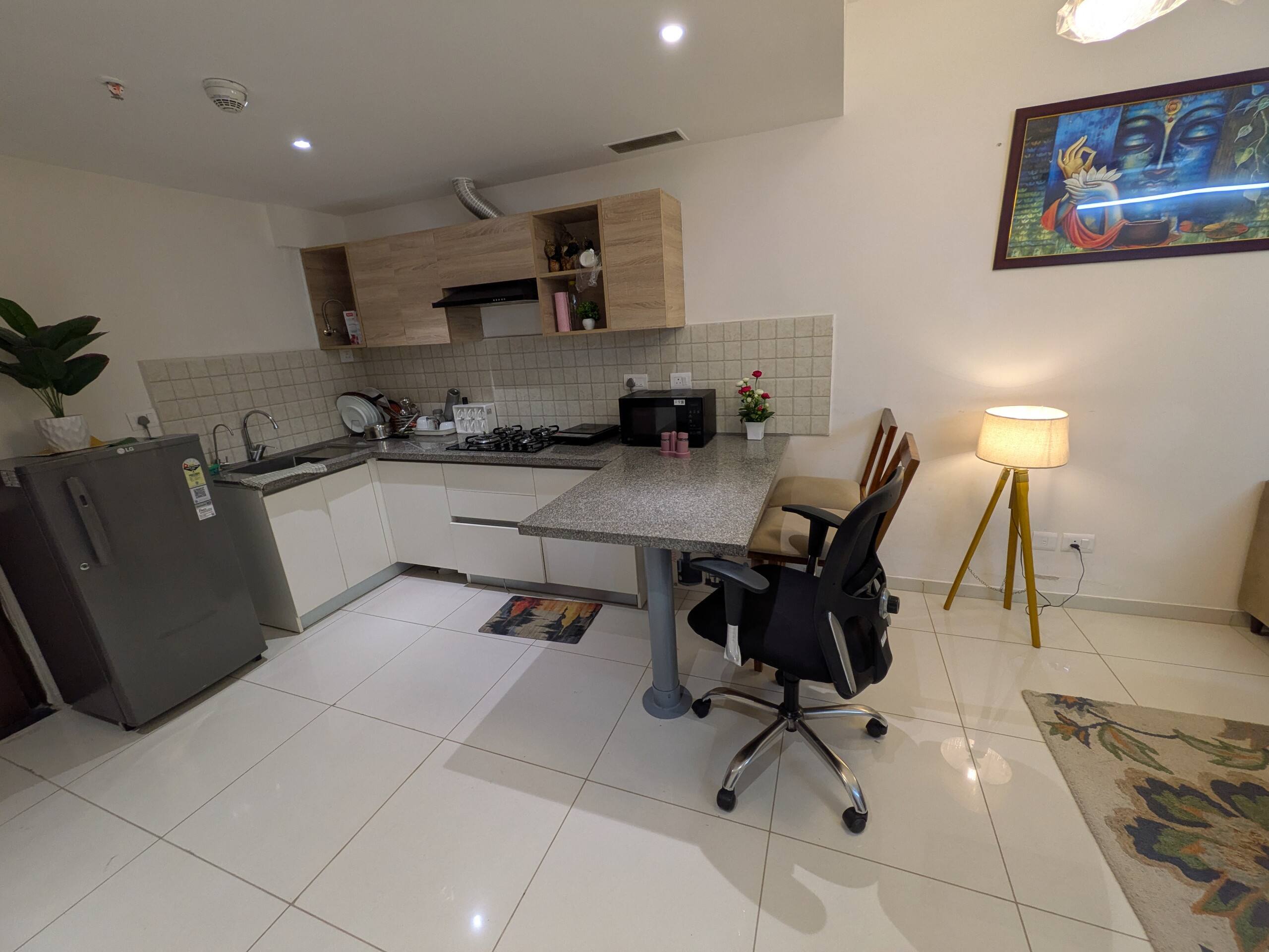 Work desk with an ergonomic mesh chair beside the kitchen