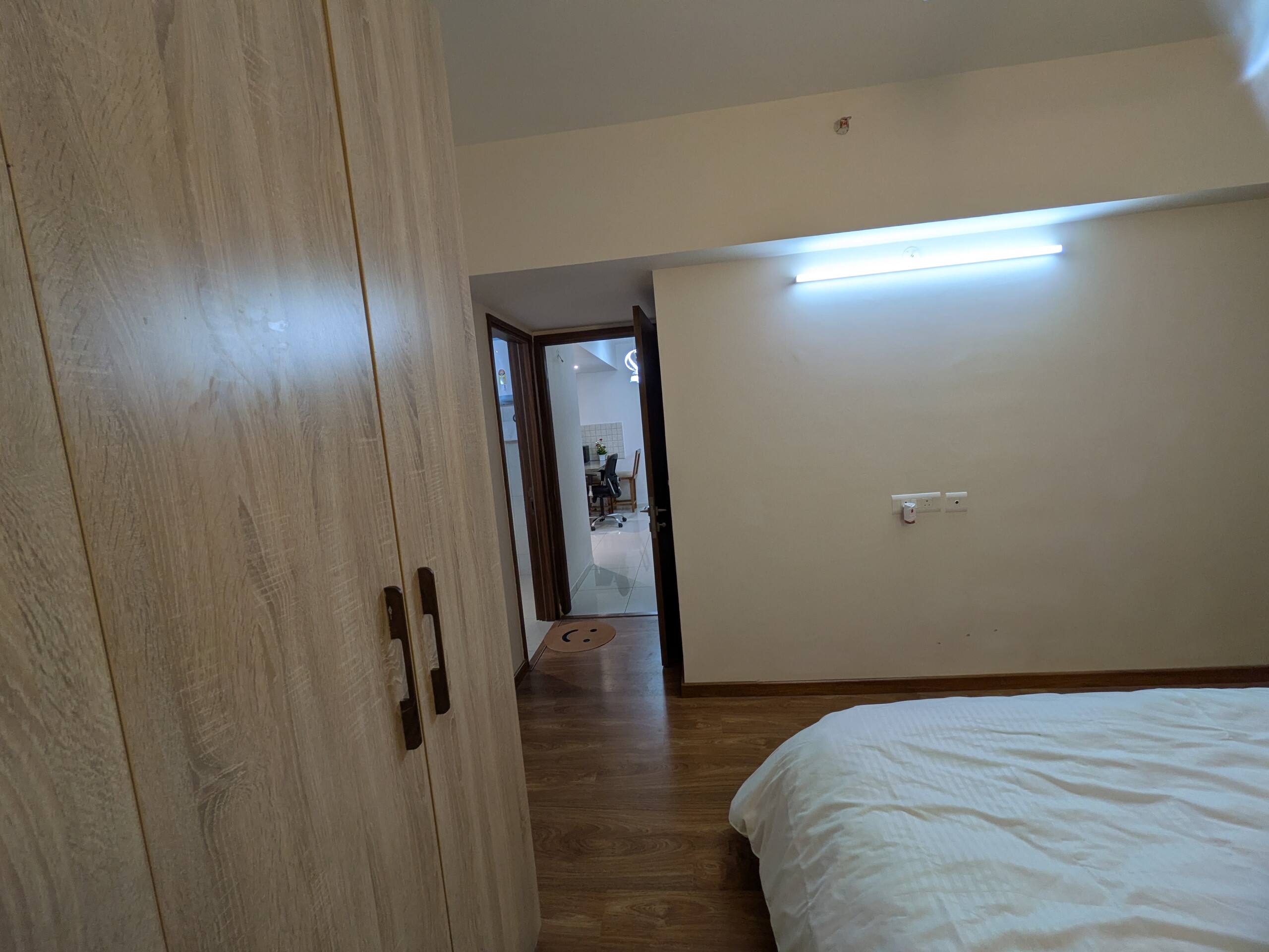 Bedroom with wooden wardrobe and bed