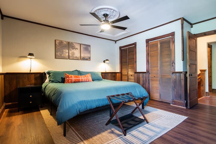 Relax in the spacious king bedroom surrounded by intricate woodworking and built-in closets