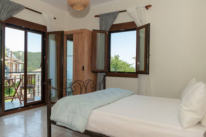Bedroom with a double bed and balcony