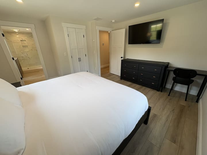 Big House: Primary Bedroom complete with a king bed, in-suite 3/4 bath, desk, and 50in Smart TV