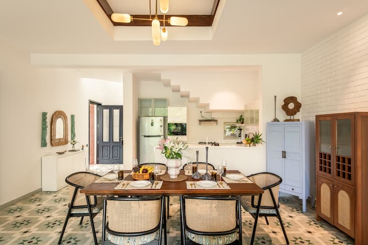 Fully equipped kitchen with modern appliances, cookware, and dining essentials.