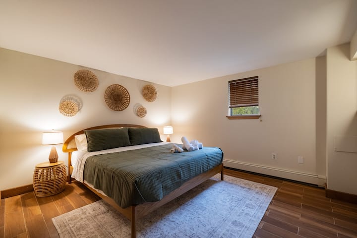 Cozy king bedroom with warm lighting and stylish natural décor