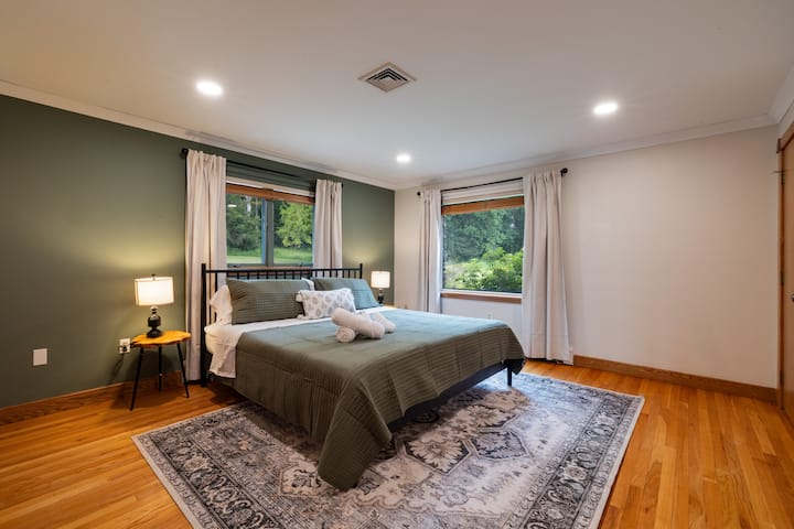 Bright, spacious bedroom with garden views and warm modern touches