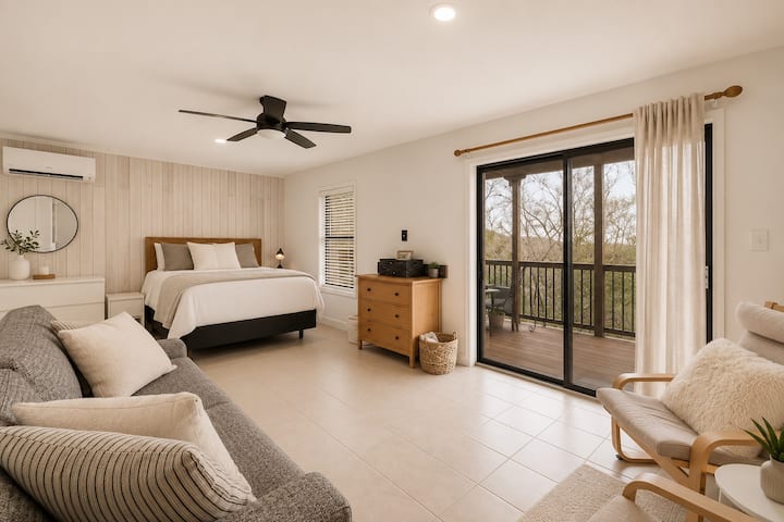 Spacious primary bedroom with private balcony and peaceful views.