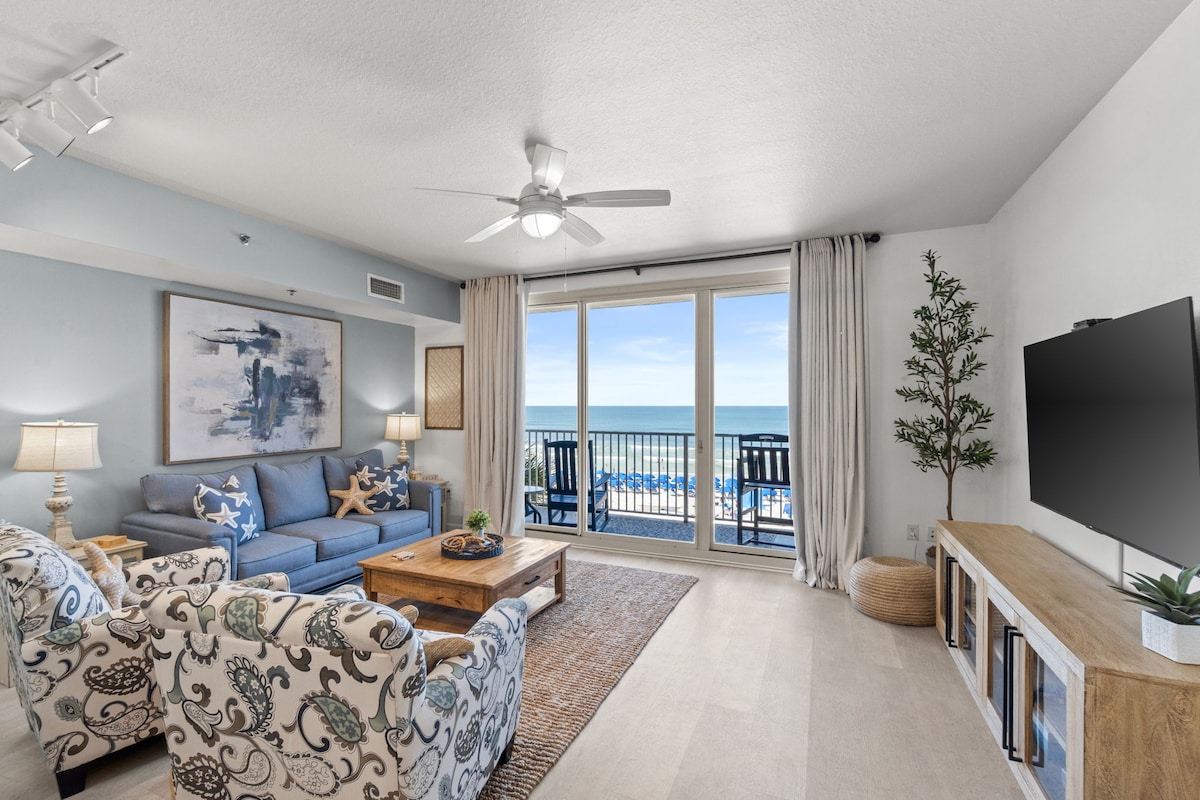 Coastal living room with private balcony and stunning ocean views