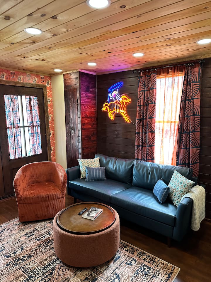 Relax in our western style living room with comfortable couches, chairs, TV, & views of the Mishawaka Riverwalk.
