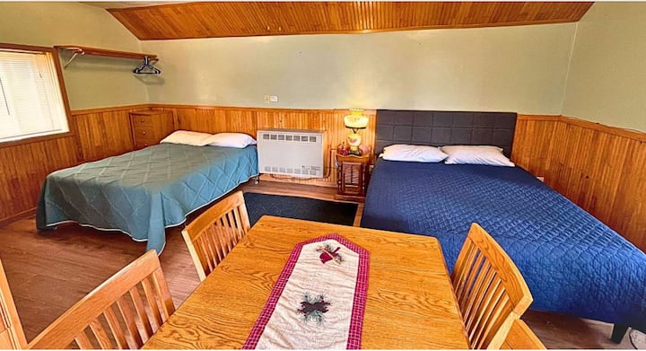 Cabin 2 is 383 square feet of space and living-dining room is equipped with two beds, a dining room table and TV.