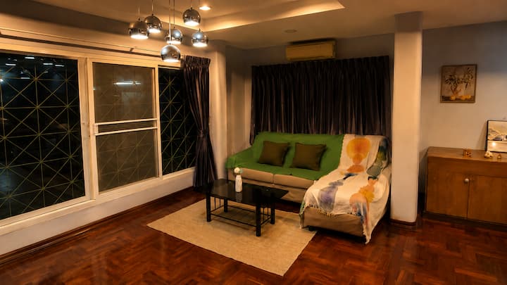 Moonlit living room with lounge seating and garden views.