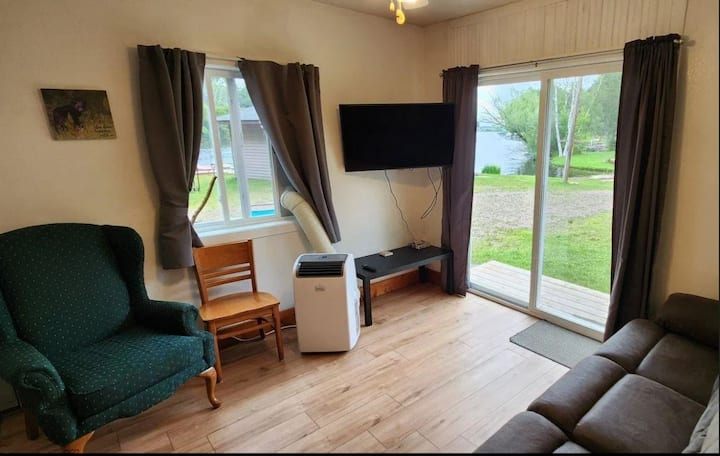 TV, air conditioner, electric fireplace and reclinable couch. Great view of lake and play area.