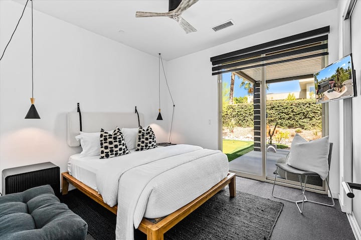 Bright bedroom with a king bed and direct access to the patio
