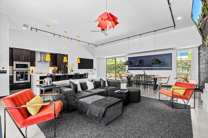 Bright living room with a fireplace and colorful modern furnishings