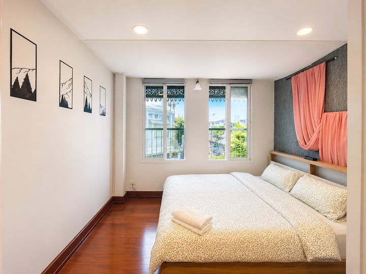Spacious master bedroom with a comfortable king-size bed and beautiful garden views.