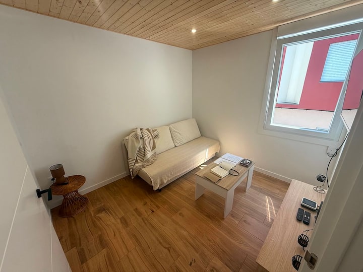 Salón con ventana a la calle y suelo de madera: todo a estrenar.