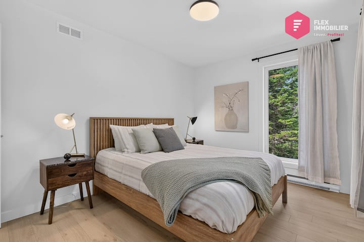 Comfortable bedroom #2 on the main floor with a queen-size bed and a double closet