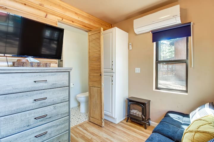 Cozy casita living space with a TV, comfortable futon, mini-split heating and A/C, plus its own bathroom just steps away.
