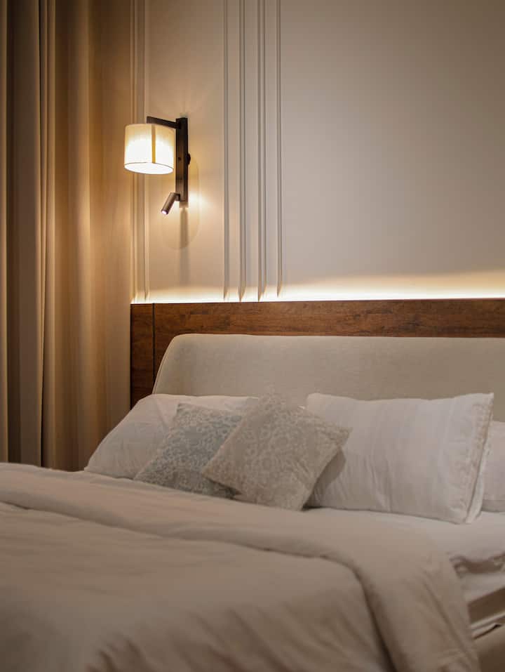 Lit confortable avec applique de lecture et draps frais