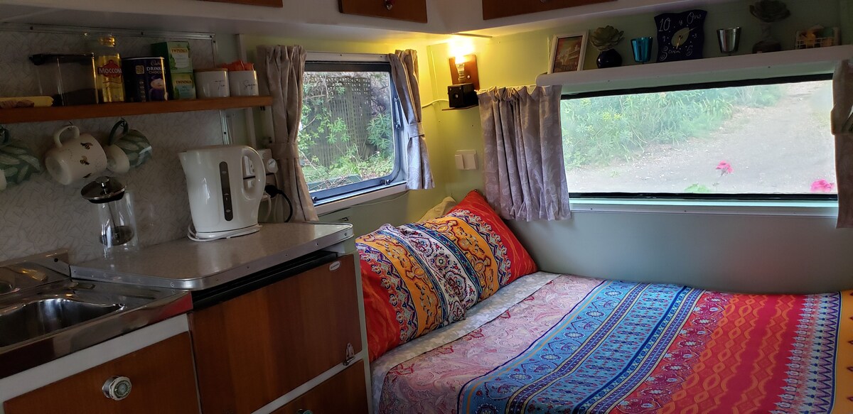 The bed is a caravan double, slightly smaller than a standard double bed and wider than a king single. It is as long as a queen bed.