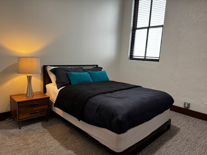 Deuxième chambre accueillante avec un lit queen confortable, des draps doux et des touches modernes. Idéal pour les invités ou les compagnons de voyage, offrant confort, intimité et une retraite reposante après une journée bien remplie.