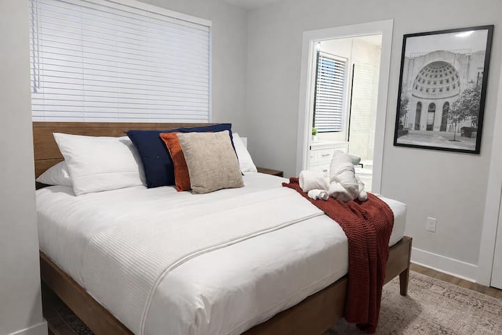 Recámara luminosa y elegante con una cómoda cama tamaño queen y acabados modernos.
