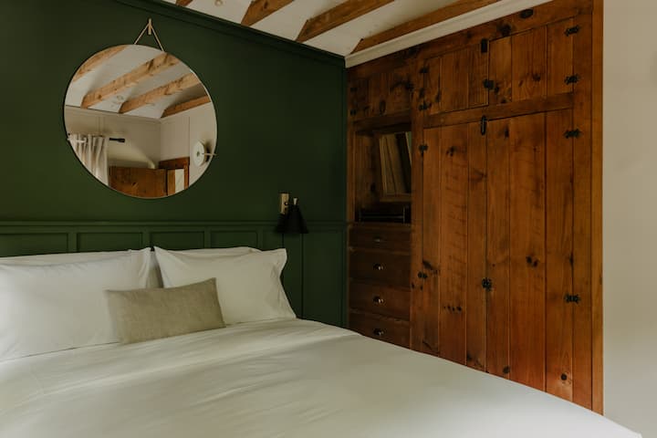 Melt into a queen bed fitted with premium 500-thread-count sheets and plush down comforters.
