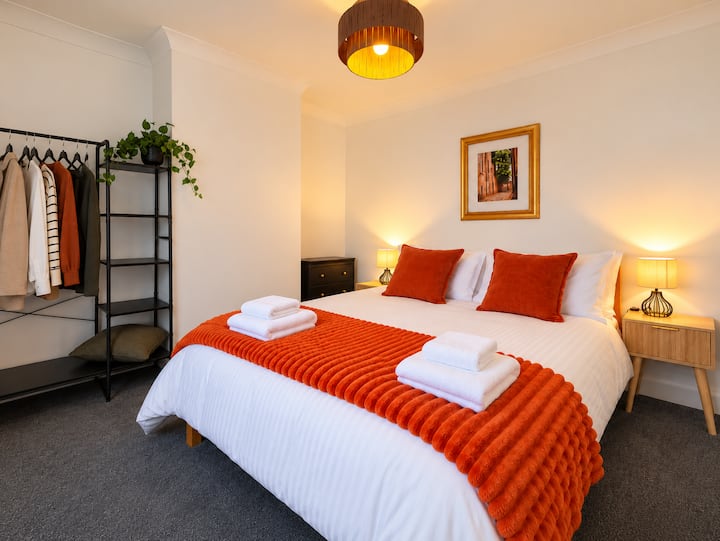 King size bed, usb sockets, hangers, draws, bed side tables, lights, mirror,  blanket, bedding, pillows, cushions.